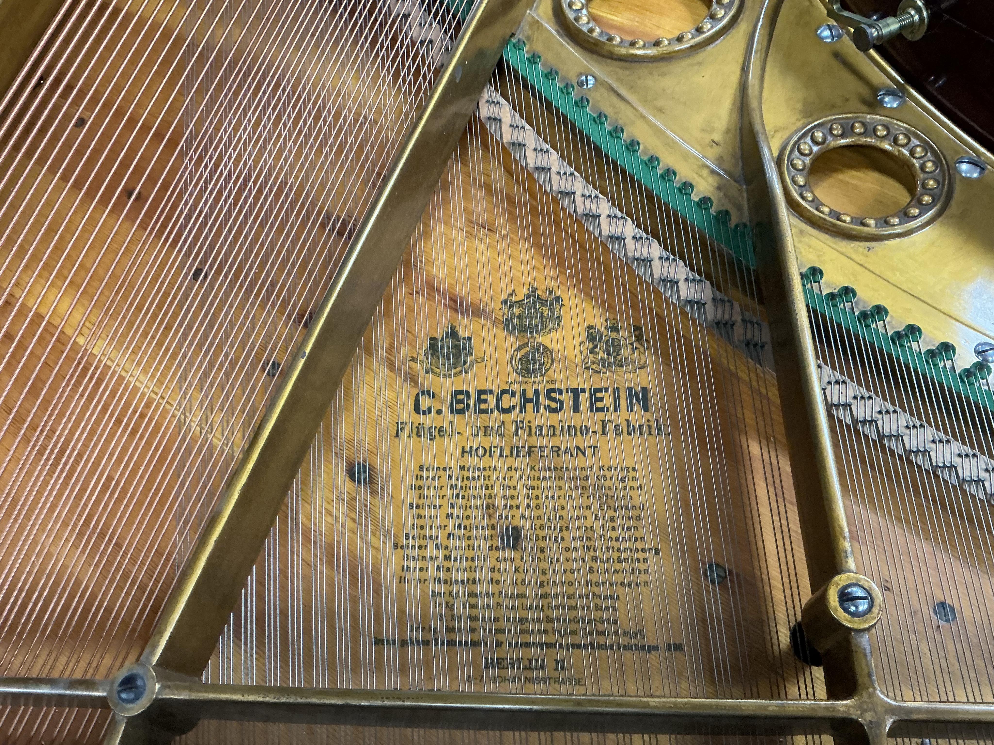 A Bechstein mahogany cased boudoir grand piano, model A, number 96003 (c.1910). Recently restrung, new felt to hammers and case re-polished, together with an adjustable ebonised piano stool. Length 182cm, depth 144cm.
